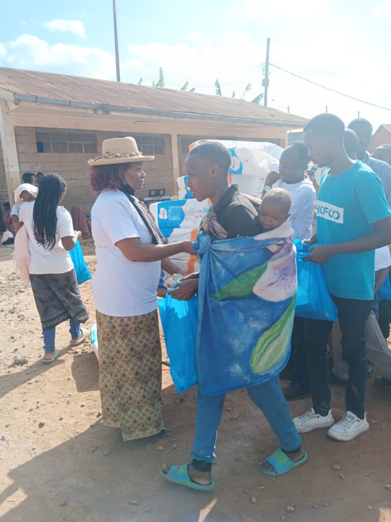 a lady serving bread to people in need