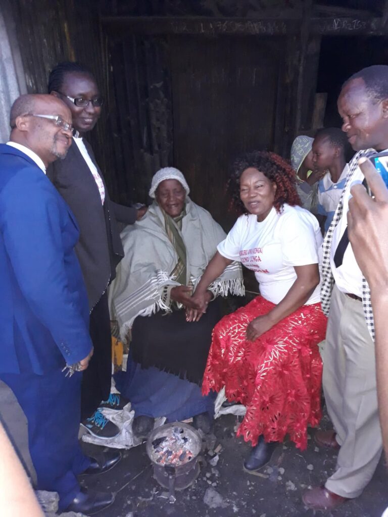 two men standing by some ladies during evangelism